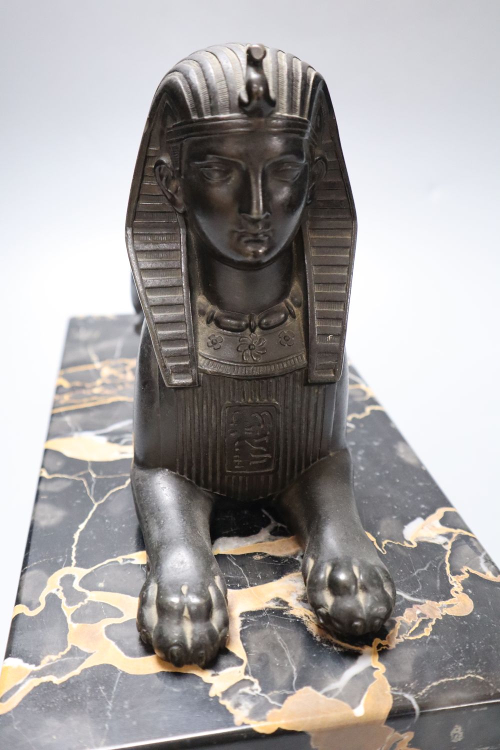 A bronzed spelter and marble sphinx, on marble plinth, height 32cm